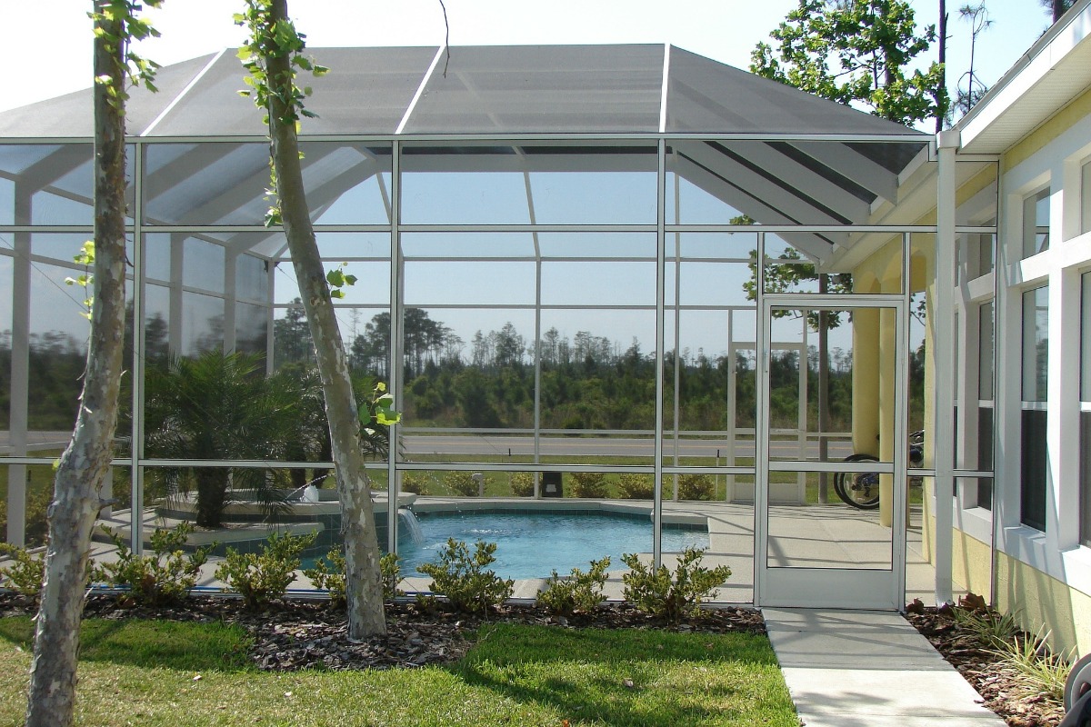 A pool with a screen enclosure