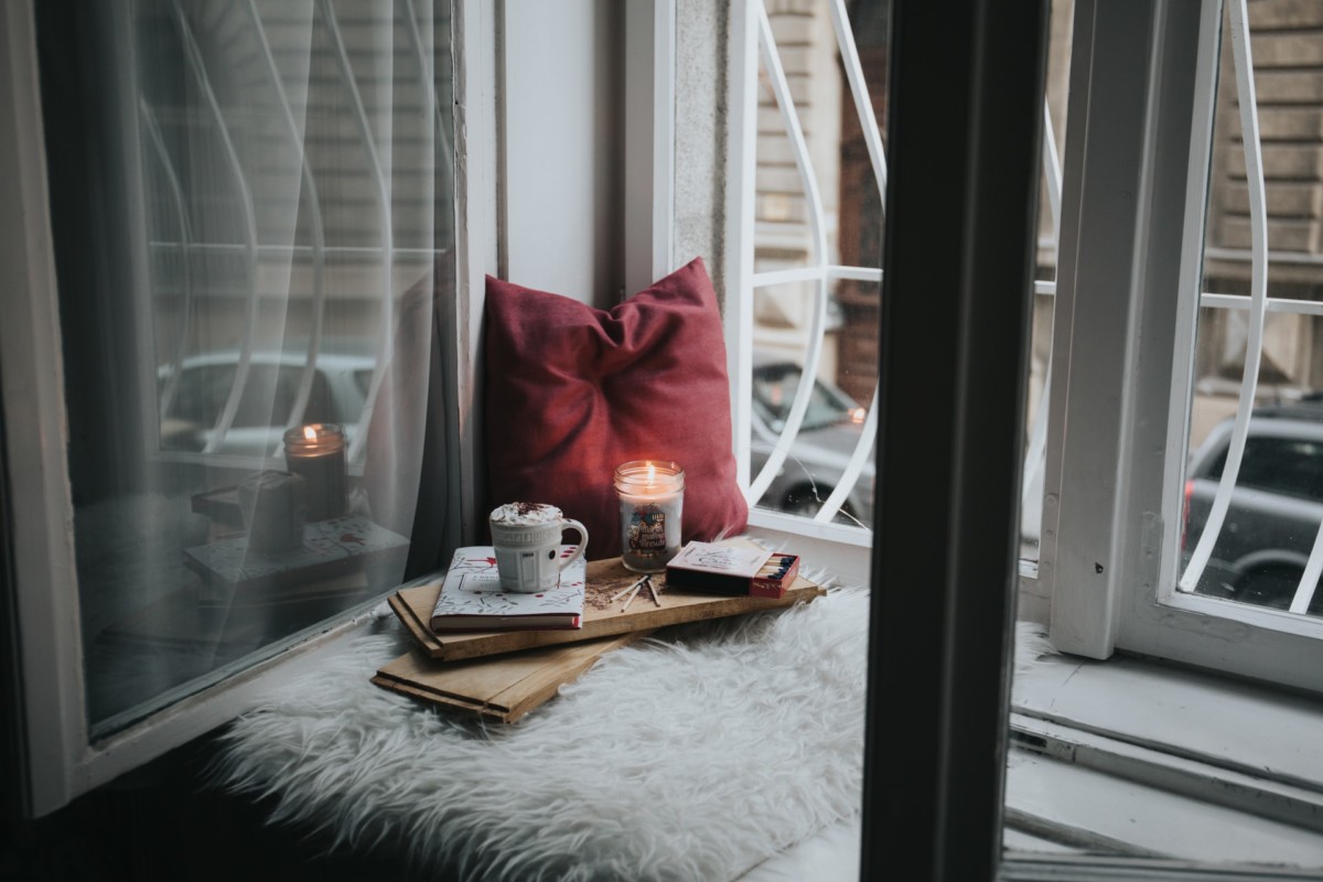 Ways to destress at home - hot cocoa and Candle by the window