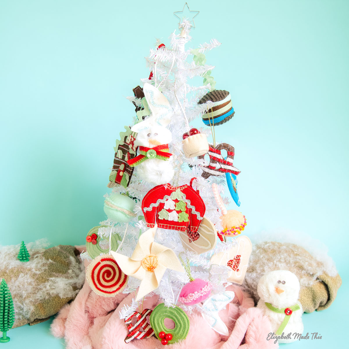 edible looking ornaments on a white tree and blue background