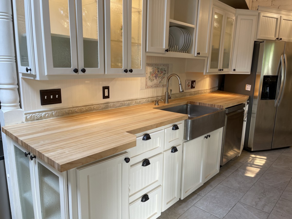 home upgrade ideas where you have a butcher block countertop with white cabinets