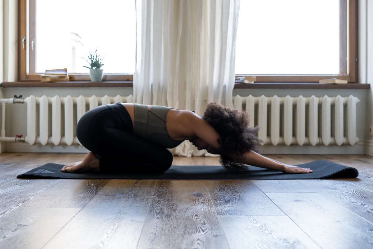 A person coping with winter blues by practicing yoga