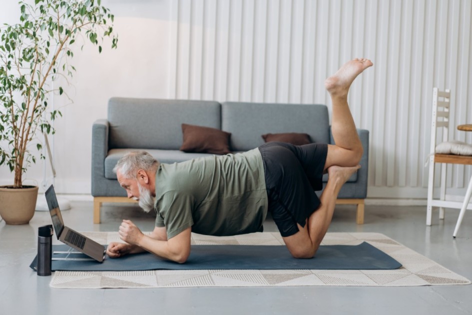 Man doing a yoga pose in the living room