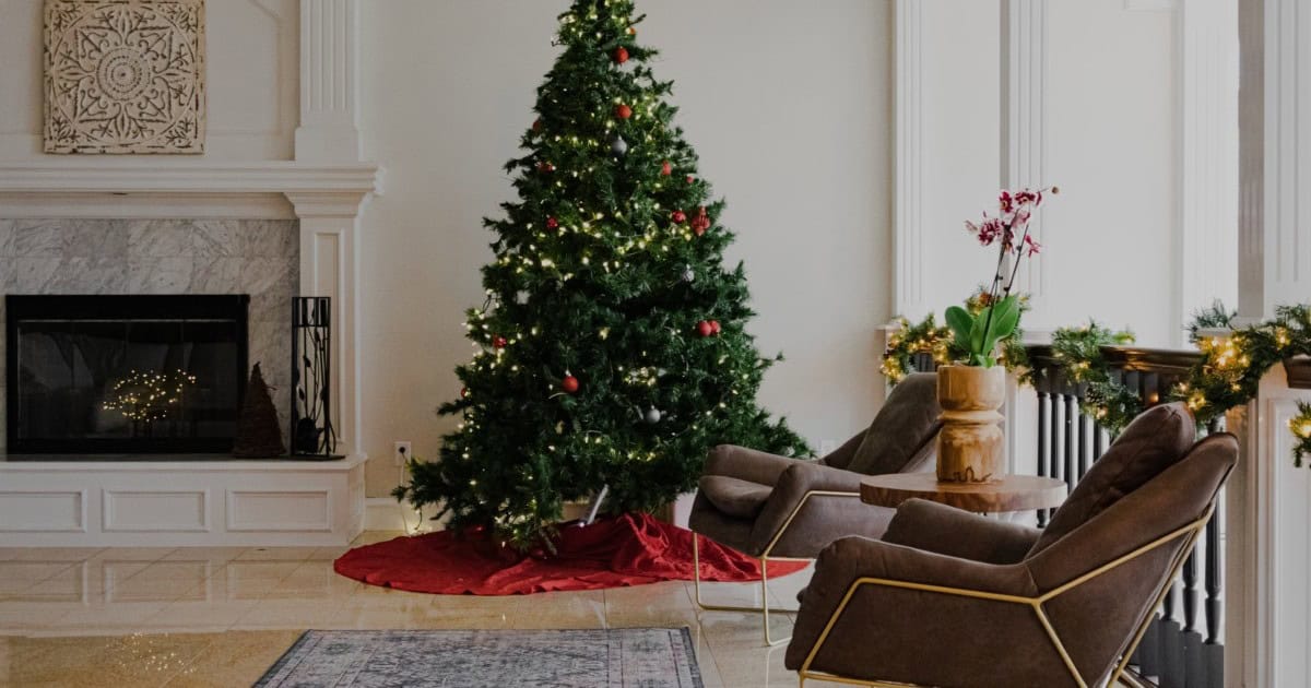 christmas tree next to fireplace