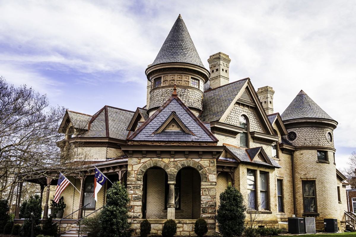 romanesque revival victorian home with a castle looking exterior, brick and turrets