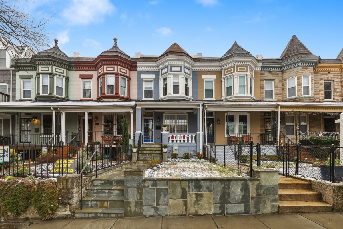 victorian style row houses with blue, green, red, and yellow exteriors with white trim