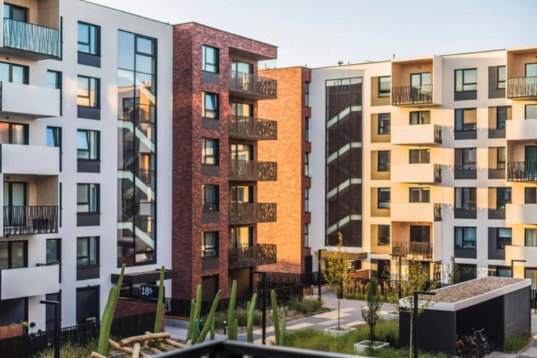 A community complex several stories high with proper apartment security