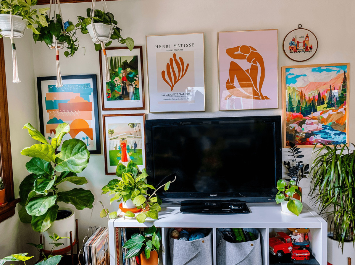 office space with a brightly colored wall and lots of art