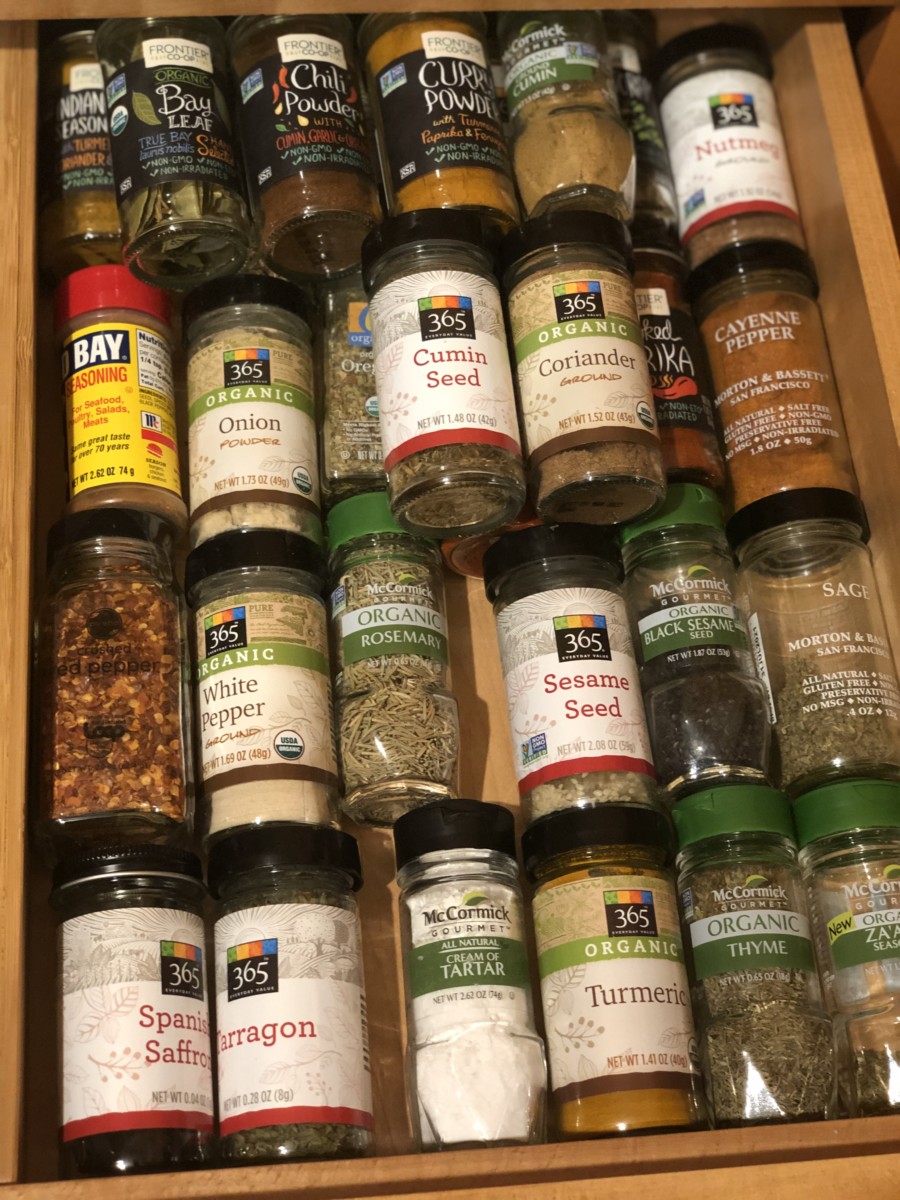 organized spice drawer with all of the spices lined up