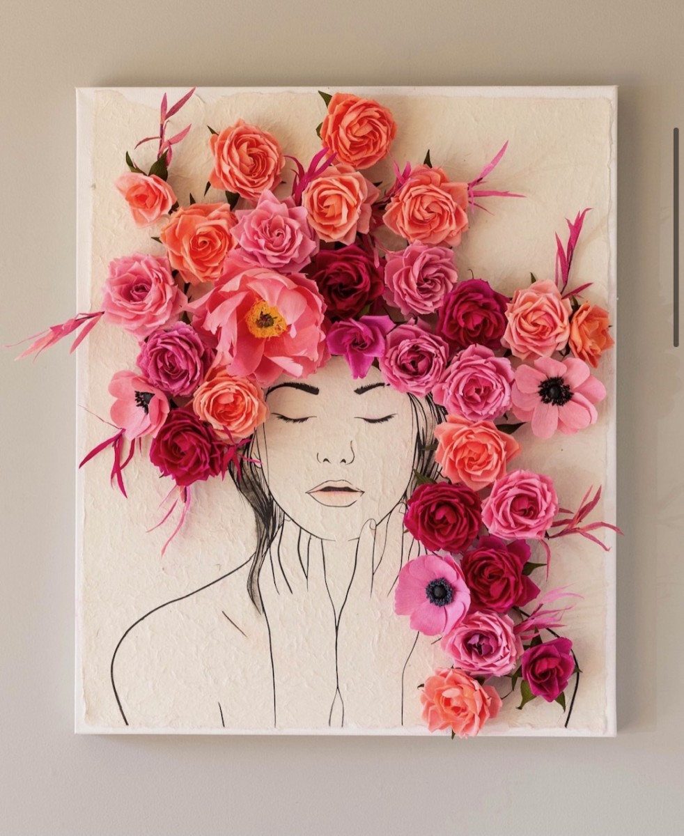 paper flower art on a canvas with orange and pink flowers