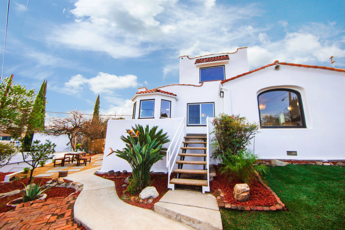 mediterranean style house with white exterior and terra cotta roofs