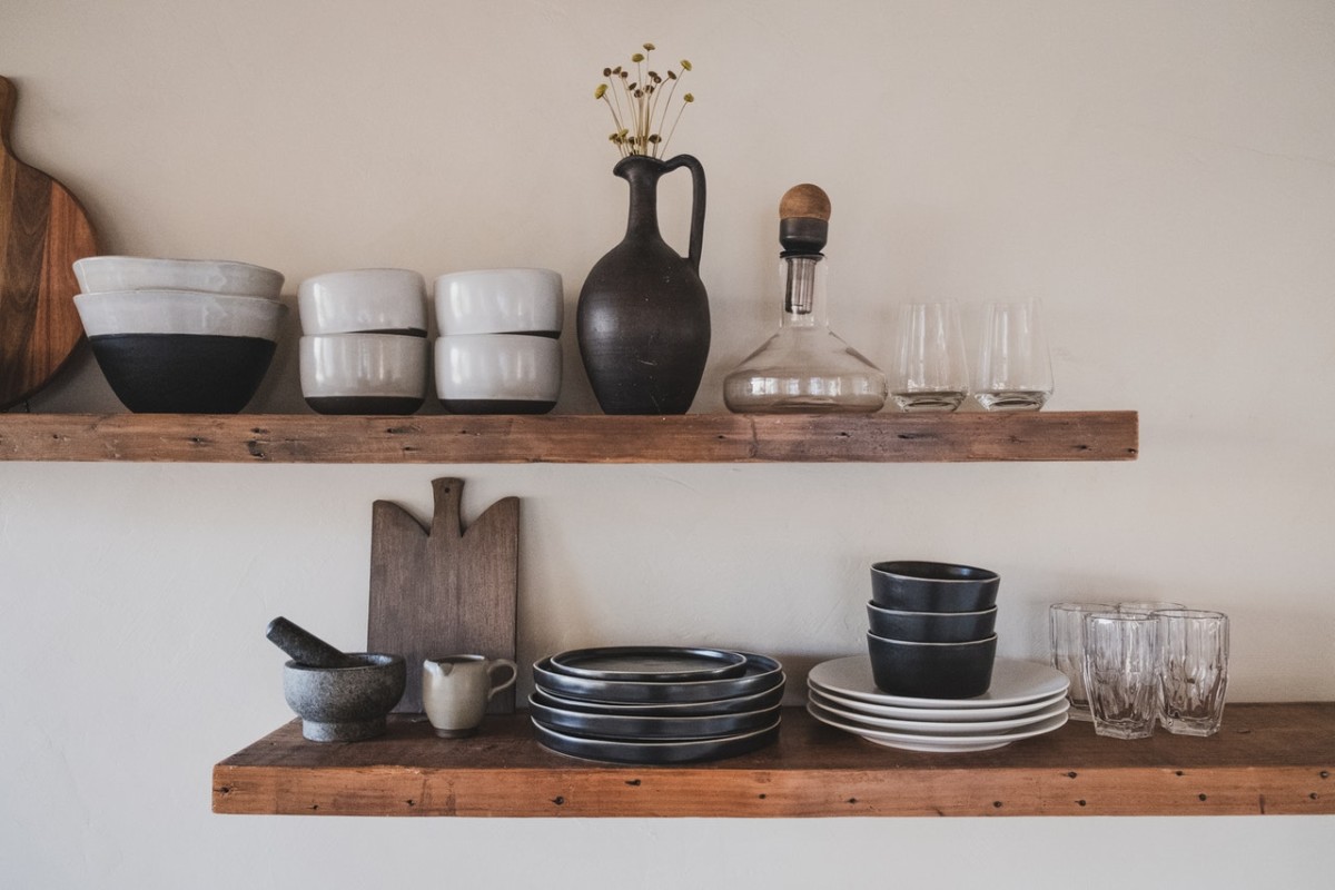 Ceramic bowls, plates and vases displayed on a shelf