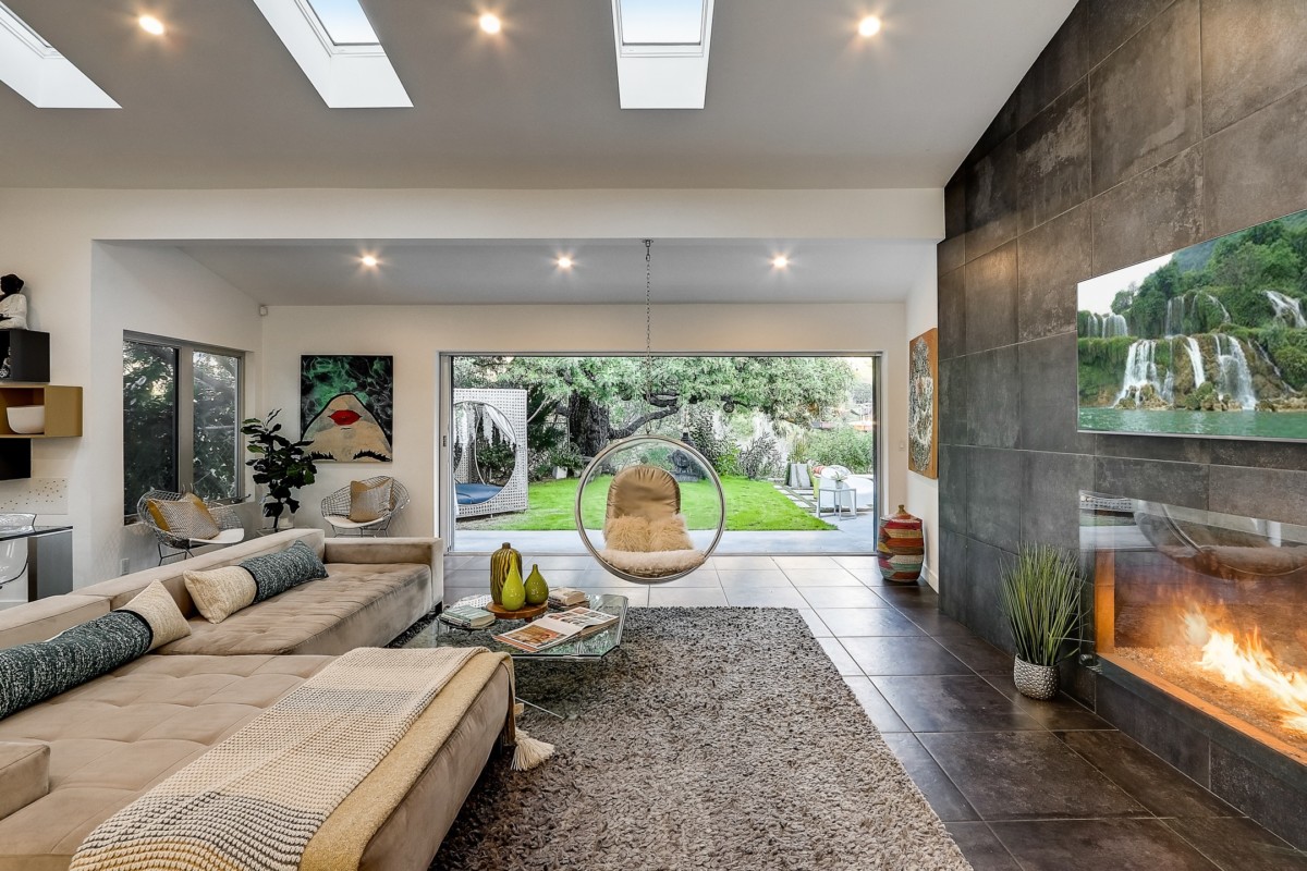 living room with skylights and indoor outdoor living