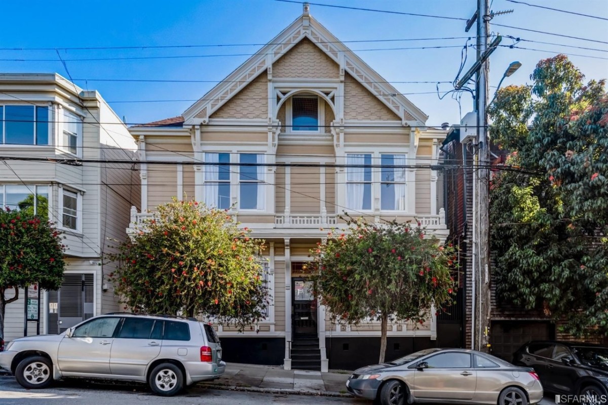 historic houses in san francisco, a yellow queen anne style home