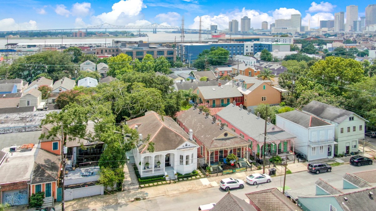aerial view of historic homes in new orleans with the skyline in the background