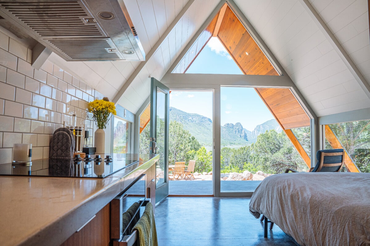 At 400 square feet of polished concrete floor, this triangle-shaped tiny house in Colorado is the perfect unique vacation rental getaway for travelers. The coded door makes it easy for guests to enter and exit as they please.  Colorado's Thimble Rock Point, Cliffs in Unaweep Canyon is visible out the front glass window from the master bedroom. _ getty