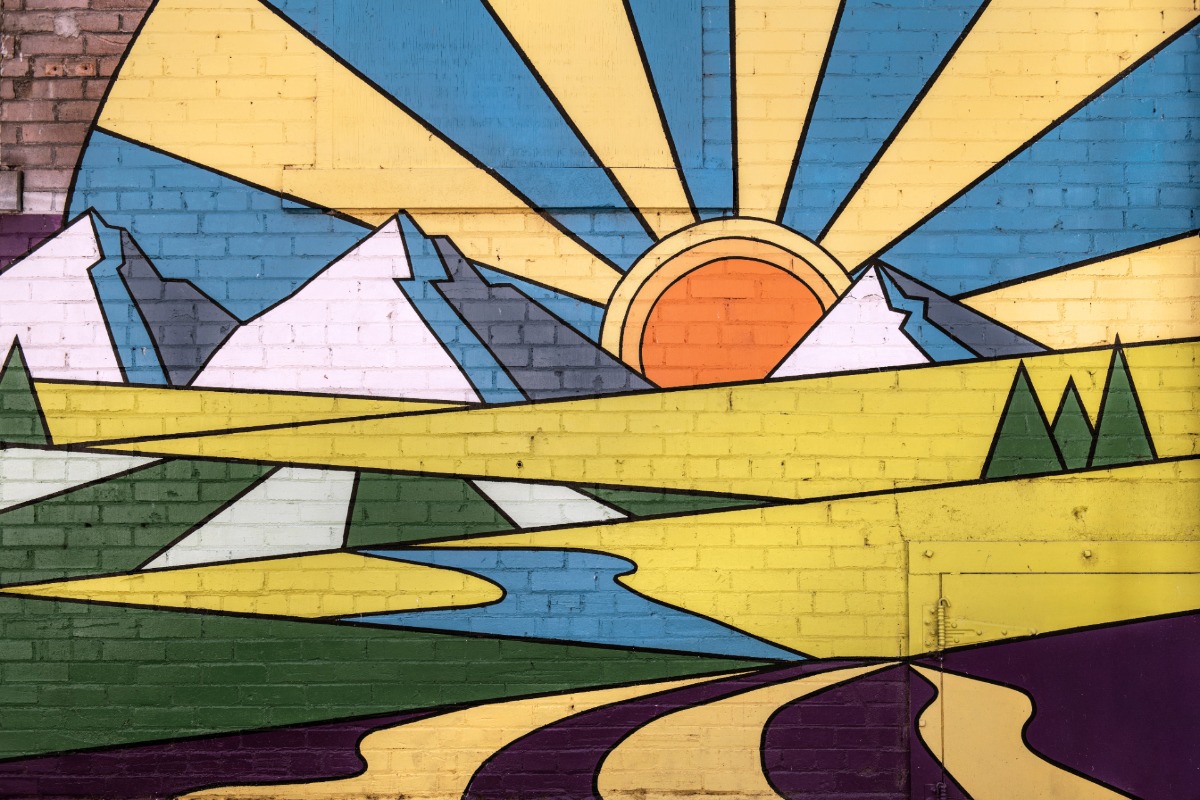 A mural of the sun and mountains