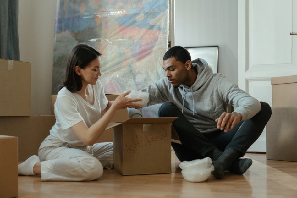 Couple moving in together with boxes of belongings