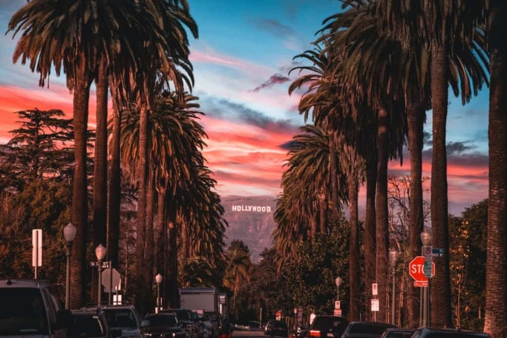 los angeles street with the hollywood sign in the background