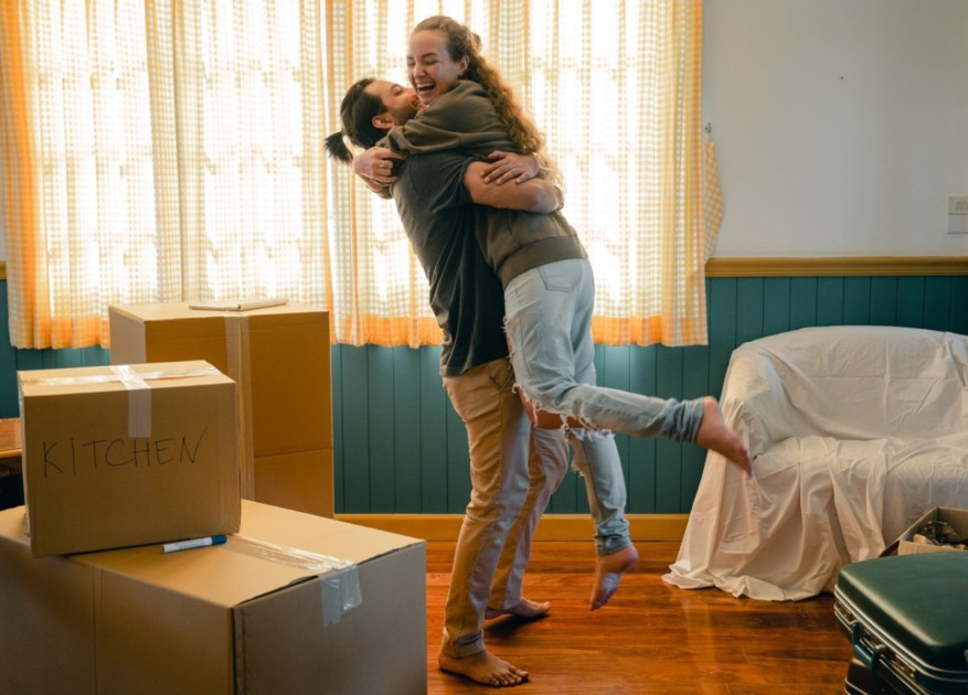 A couple unpacking after asking each other important questions before moving in together