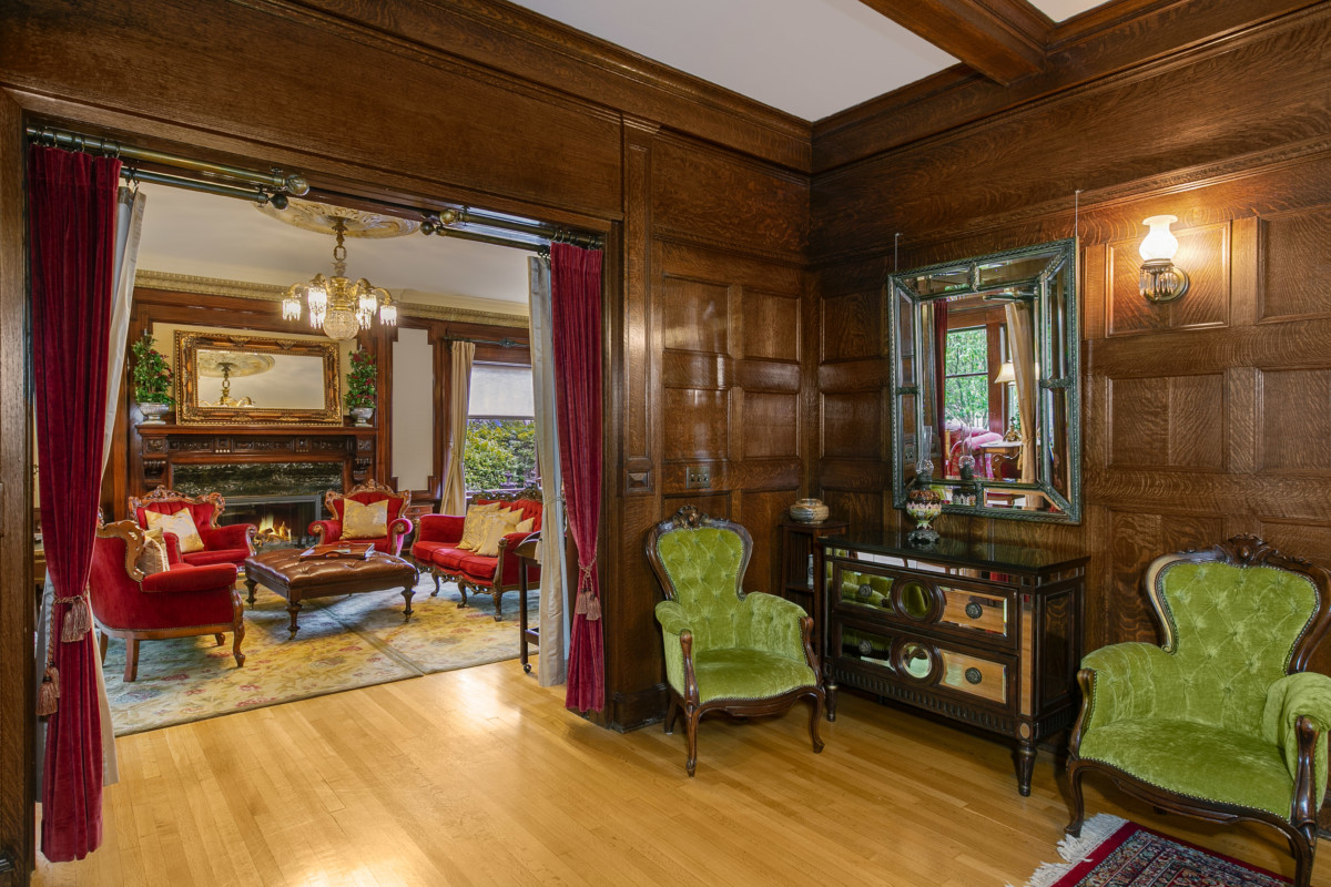 tudor home with antique furniture and green chairs