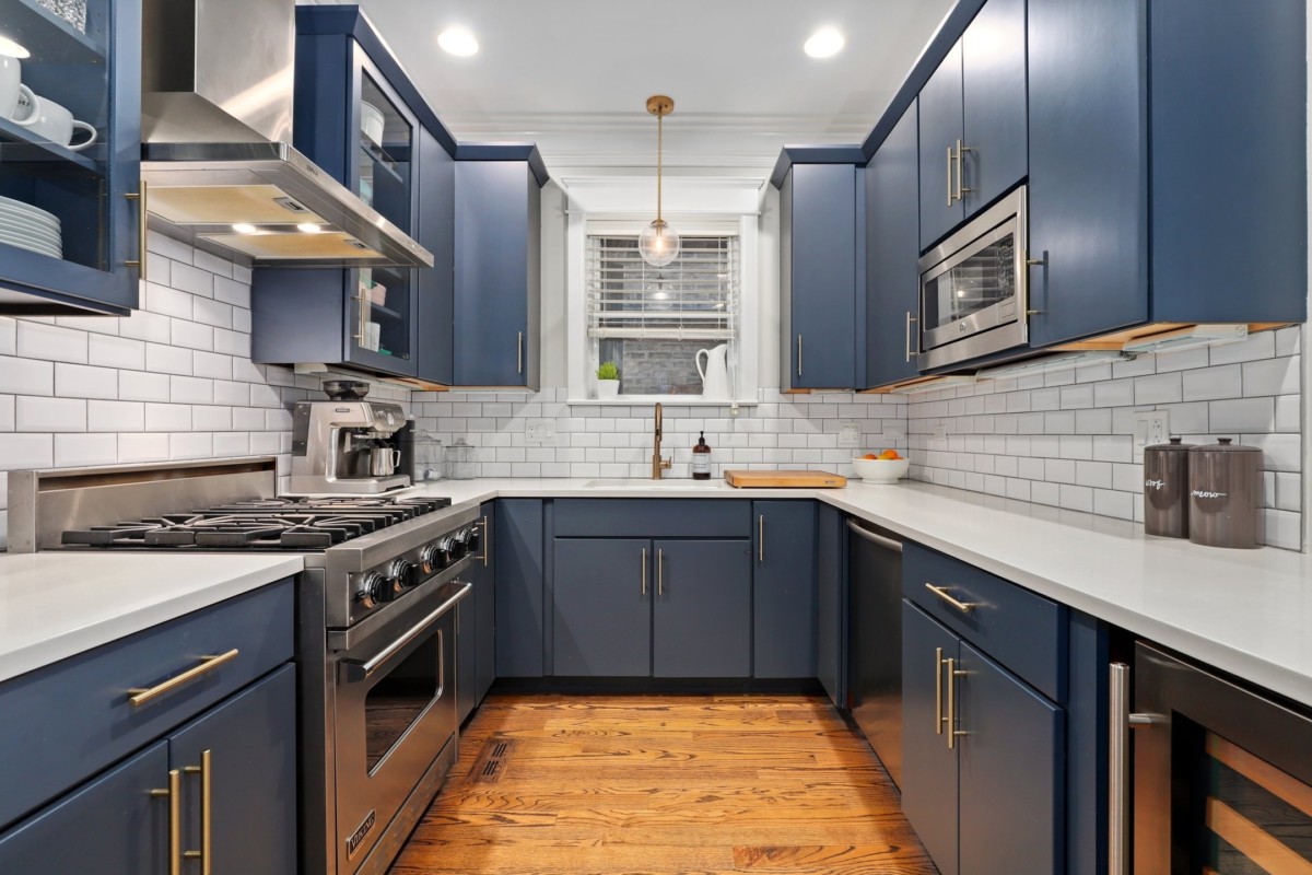 kitchen with blue cabinets and white backsplash