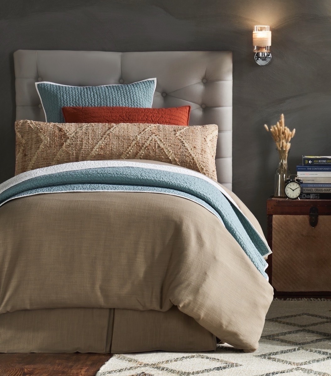 bedroom with cozy bedding layers in neutral colors