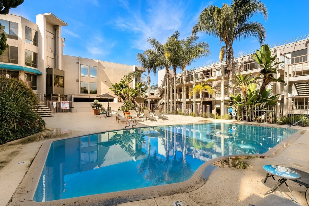 swimming pool surrounded by apartment rooms