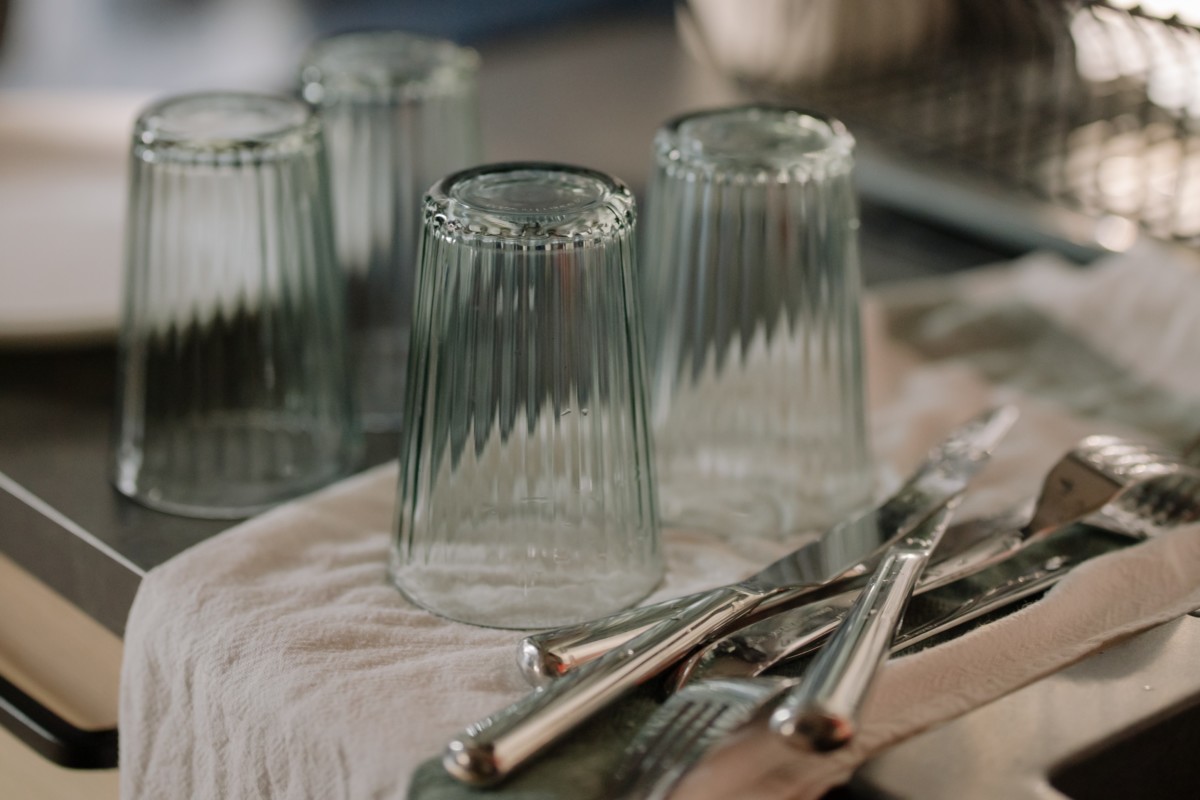 silverware and glasses on a counter