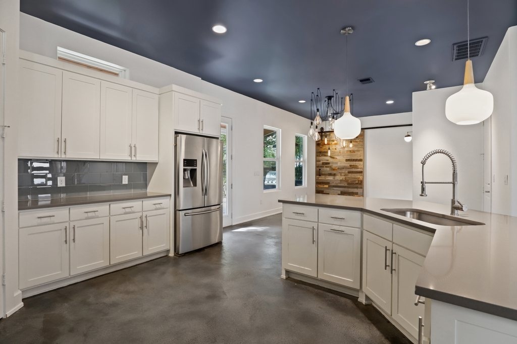 modern kitchen with white cabinets and stainless steel appliances