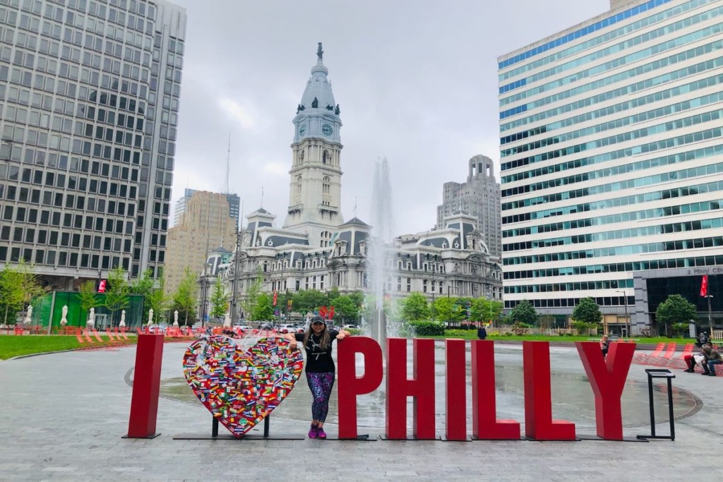 posing for picture by the I love Philadelphia sign