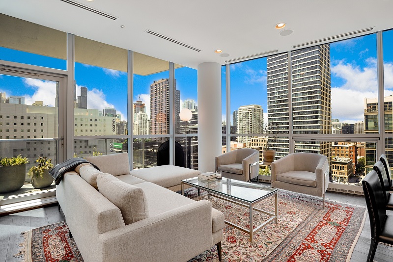 fully furnished apartment living room with a couch, rug, table, and accessories