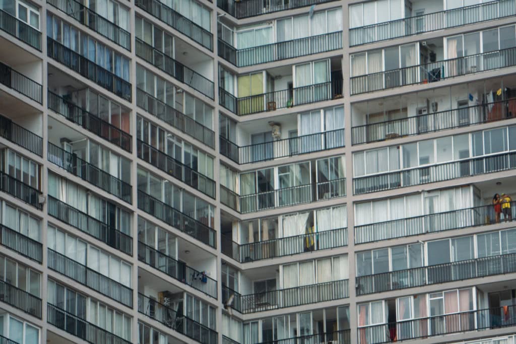 View of a modern apartment building with ceiling-to-floor windows