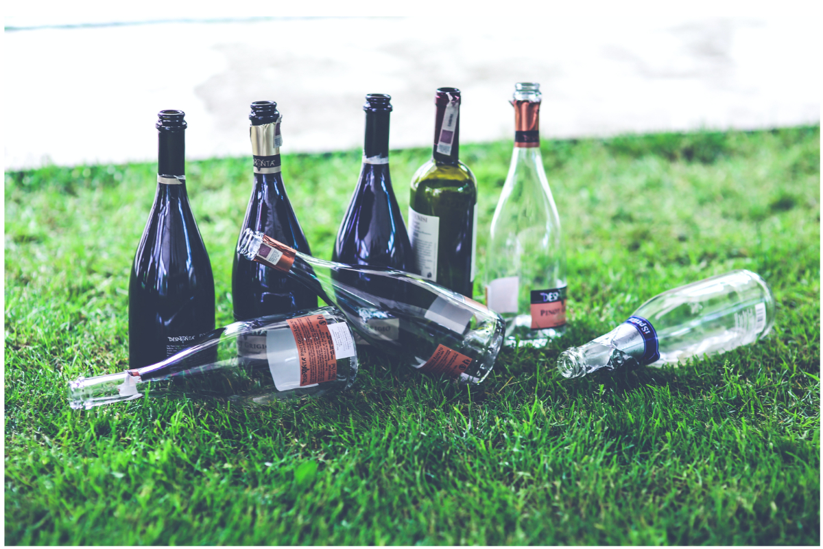 empty wine bottles in grass