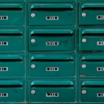 green apartment mailboxes with apartment numbers