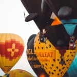 new mexico balloon festival with yellow and blue colored hot air balloons