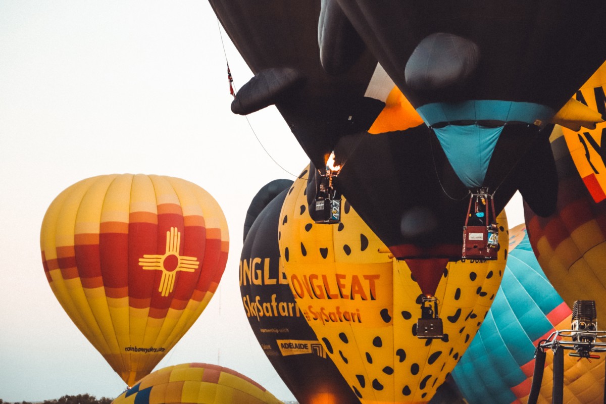 new mexico balloon festival with yellow and blue colored hot air balloons