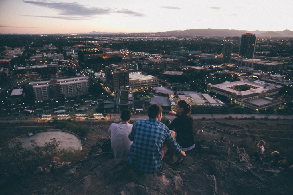 two friends on mountain looking over tempe arizona