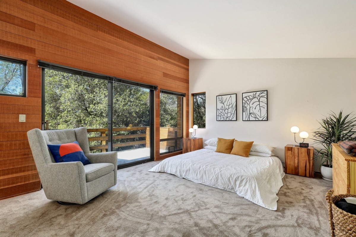 bedroom with earthy colors and wood paneled wall