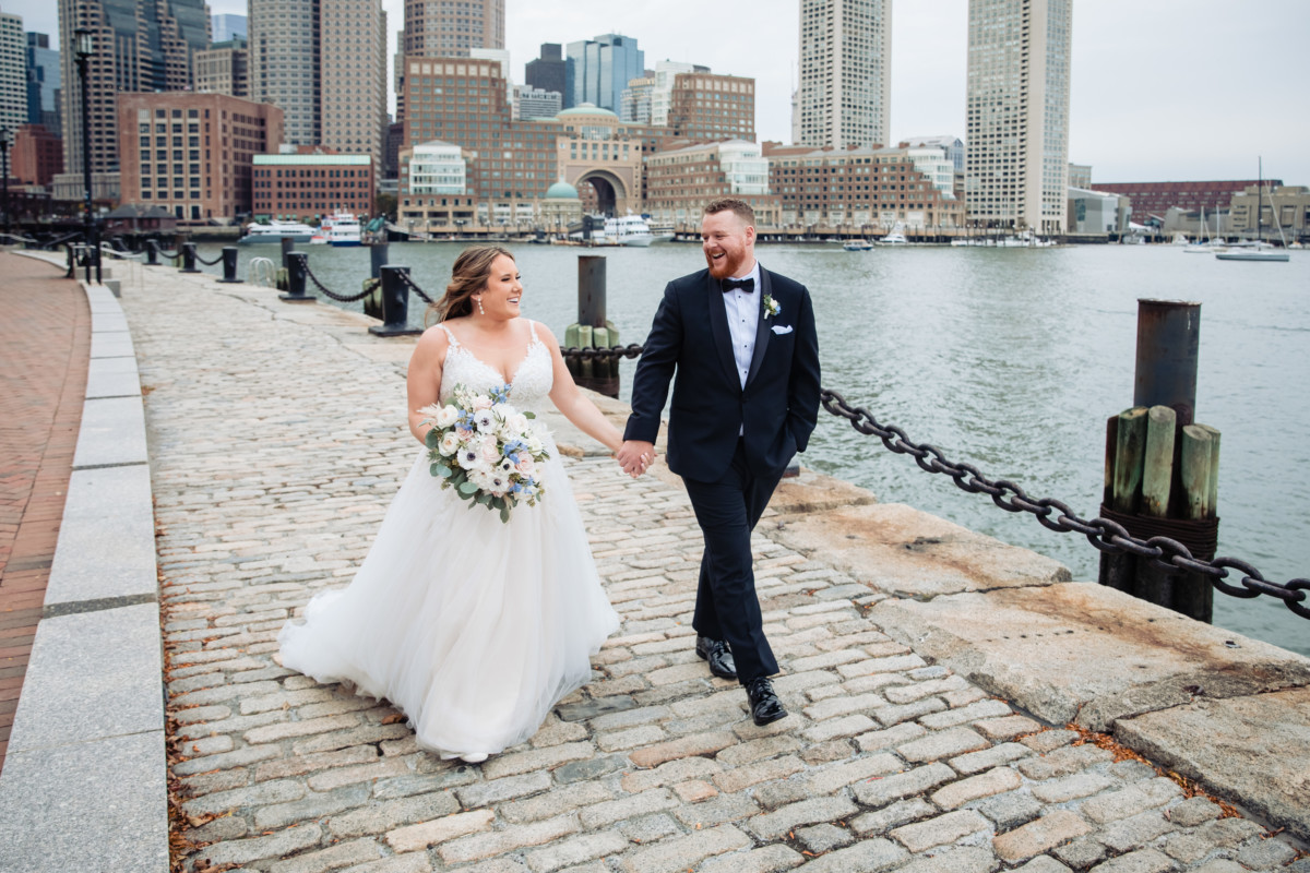 Wedding photo walking on the Boston harbor