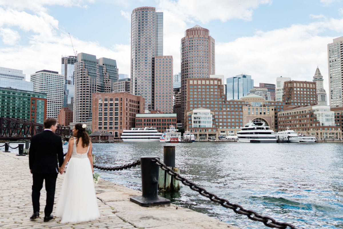 Wedding photo of a couple with the skyline behind them