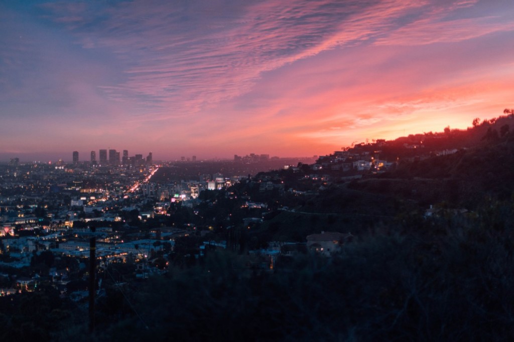 aerial view of los angeles hills at sunset with blue, pink, and orange sky