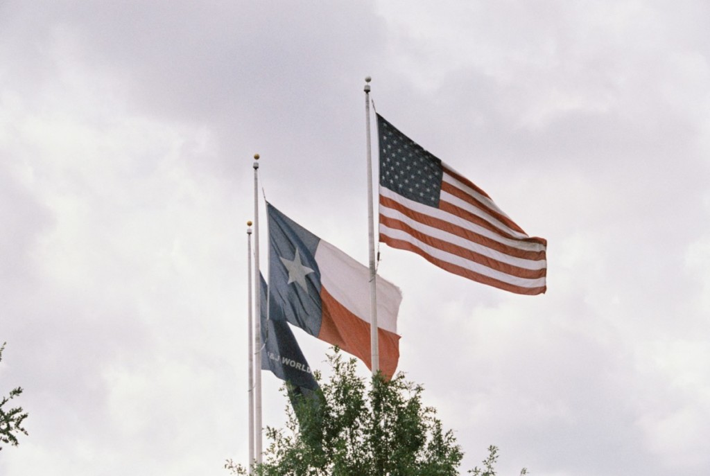 texas and american flag flowing in the window