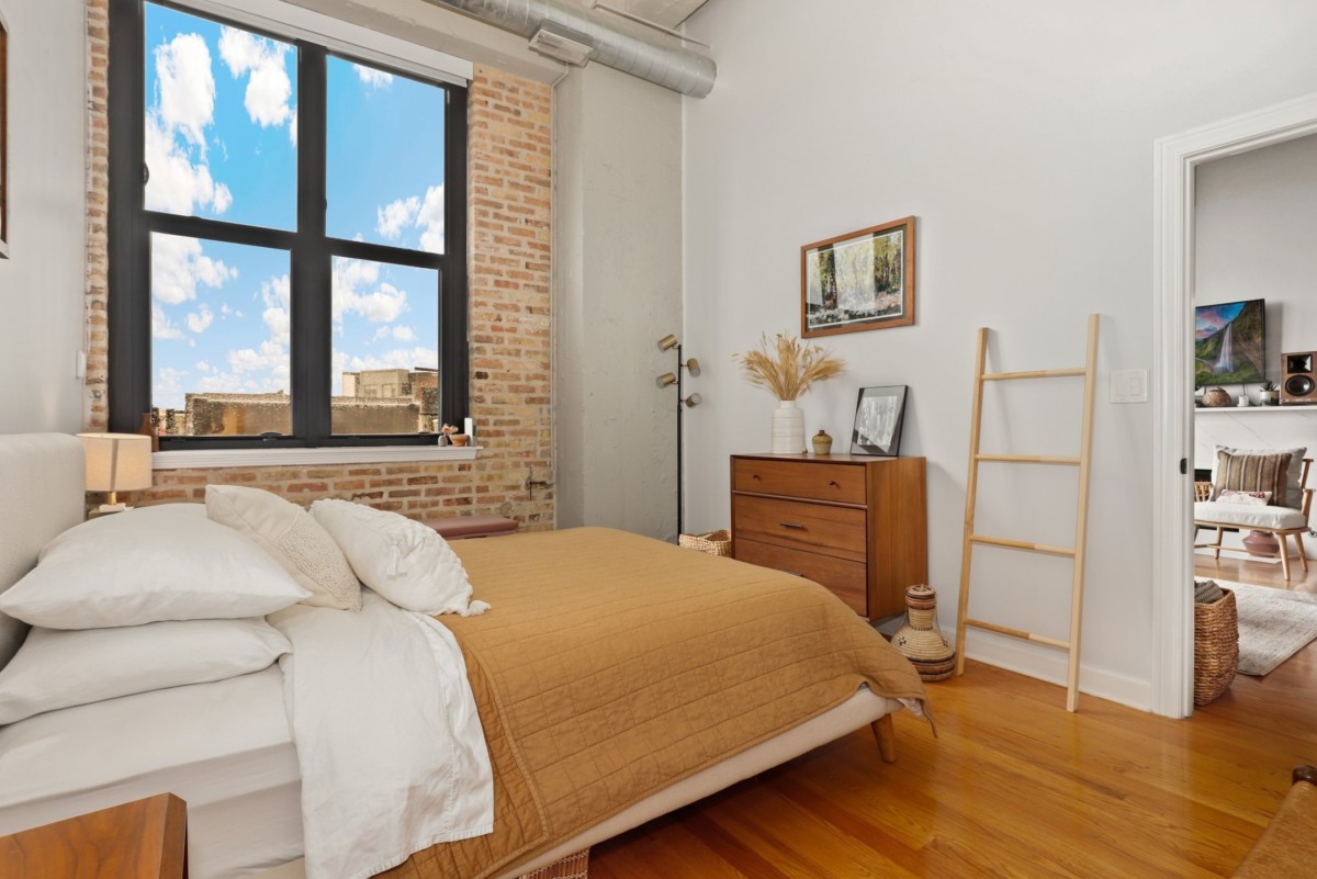 bedroom with neutral tone furnishings and a big window