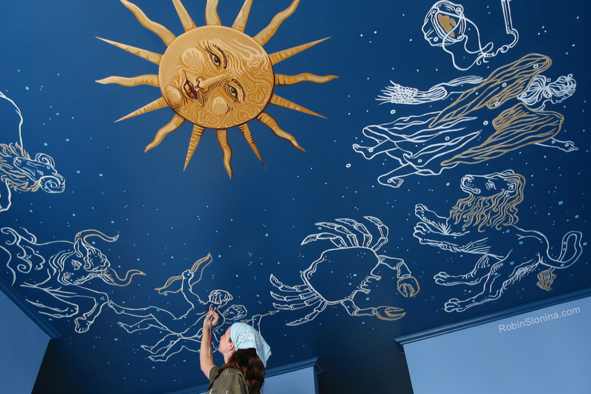 A sun mural on a ceiling 