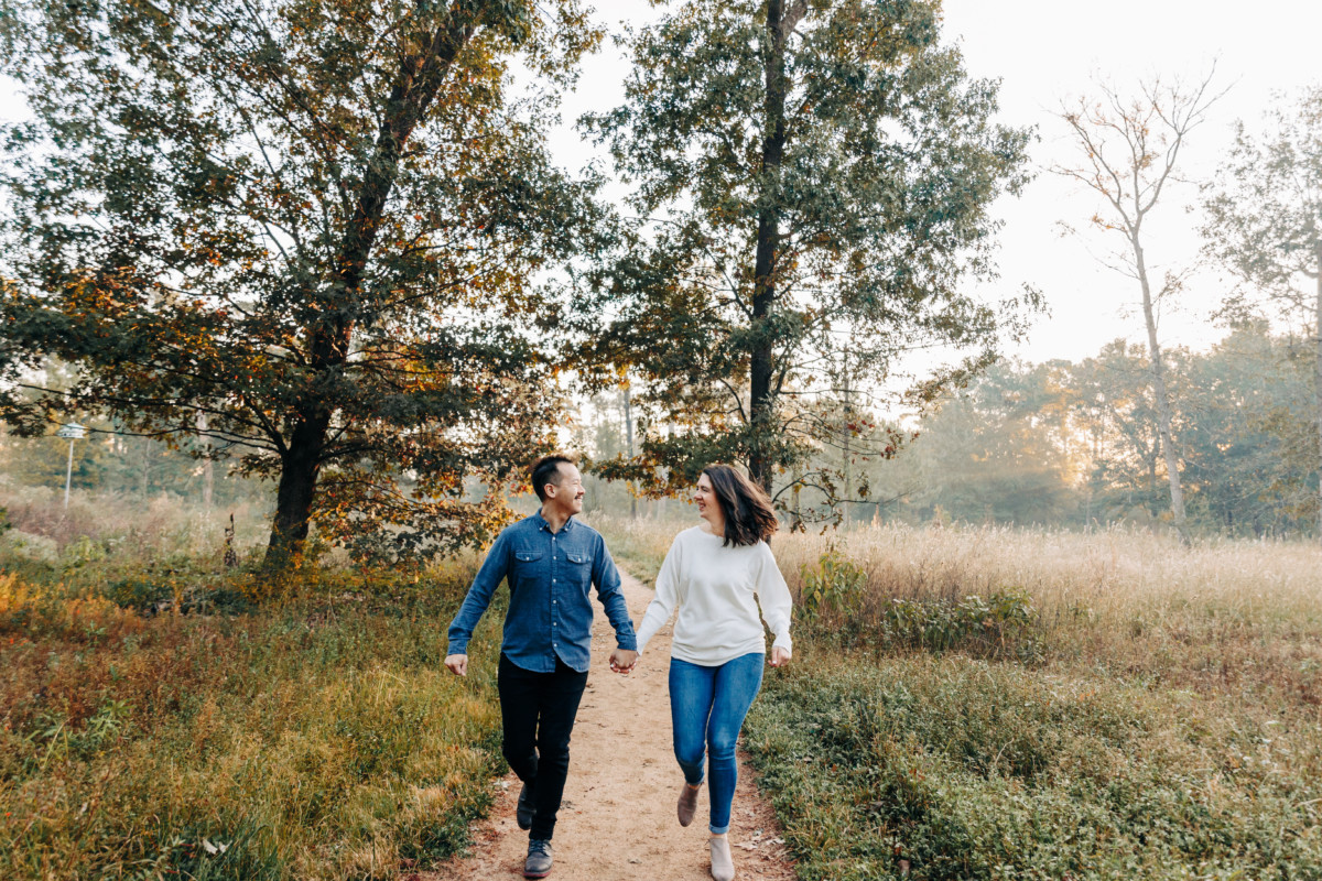 Couple running through a field in a beautiful Houston location