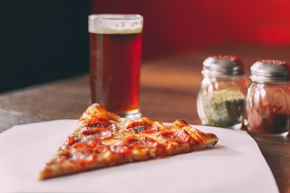 Slice of pizza and a beer.