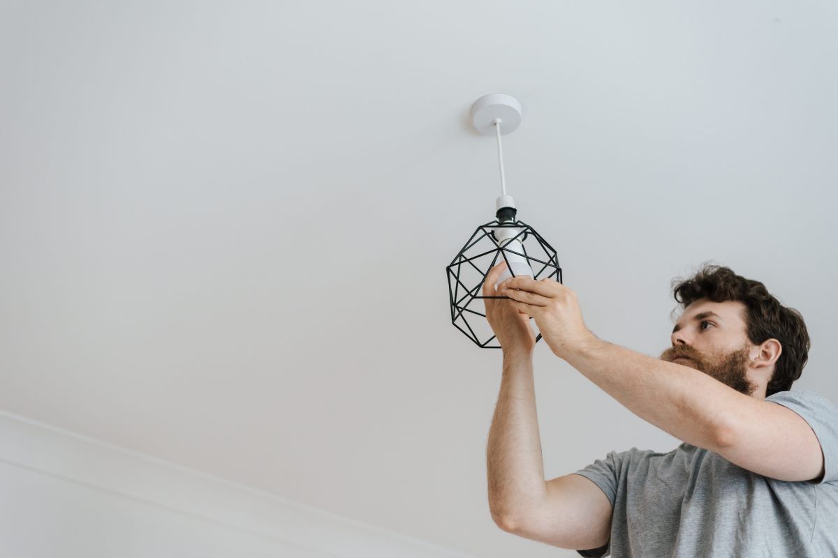 man changing a light bulb