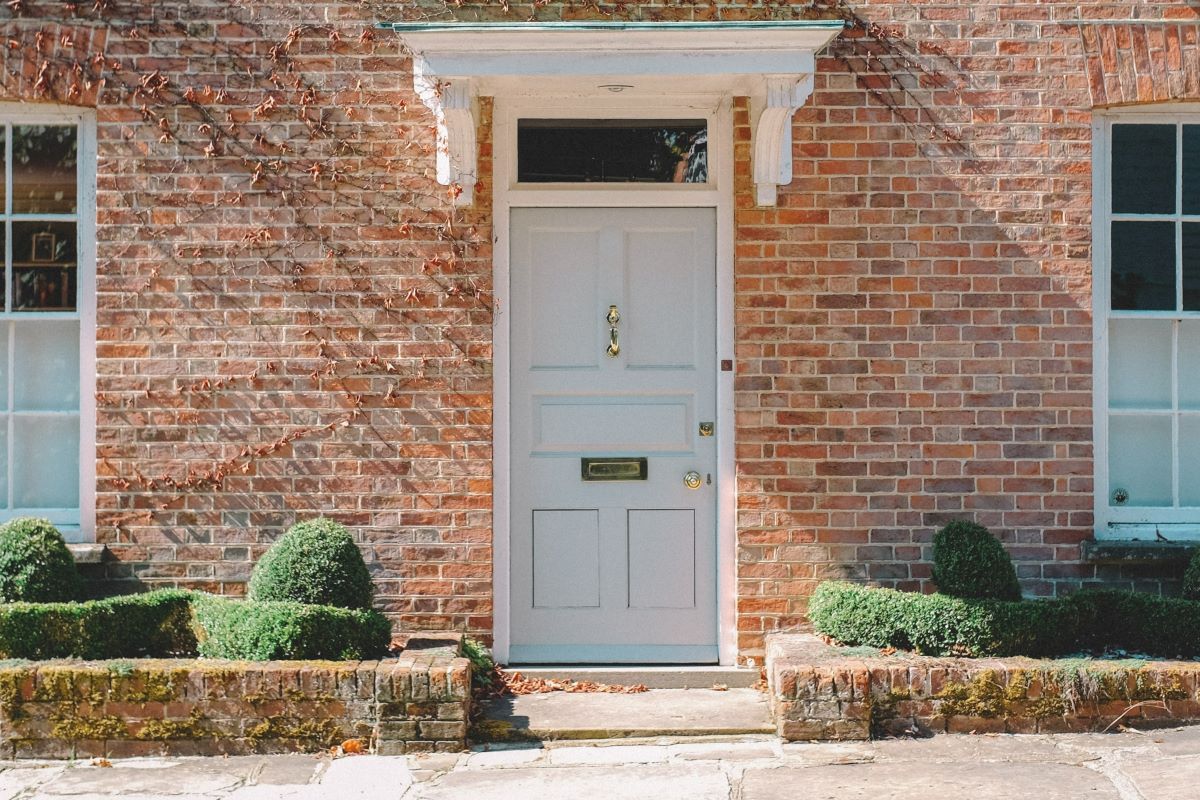 white front door on a brick house