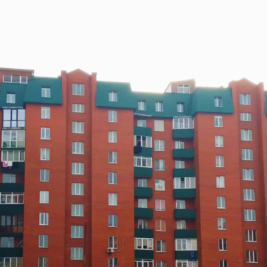 Modern block of apartments with green roofs and balconies