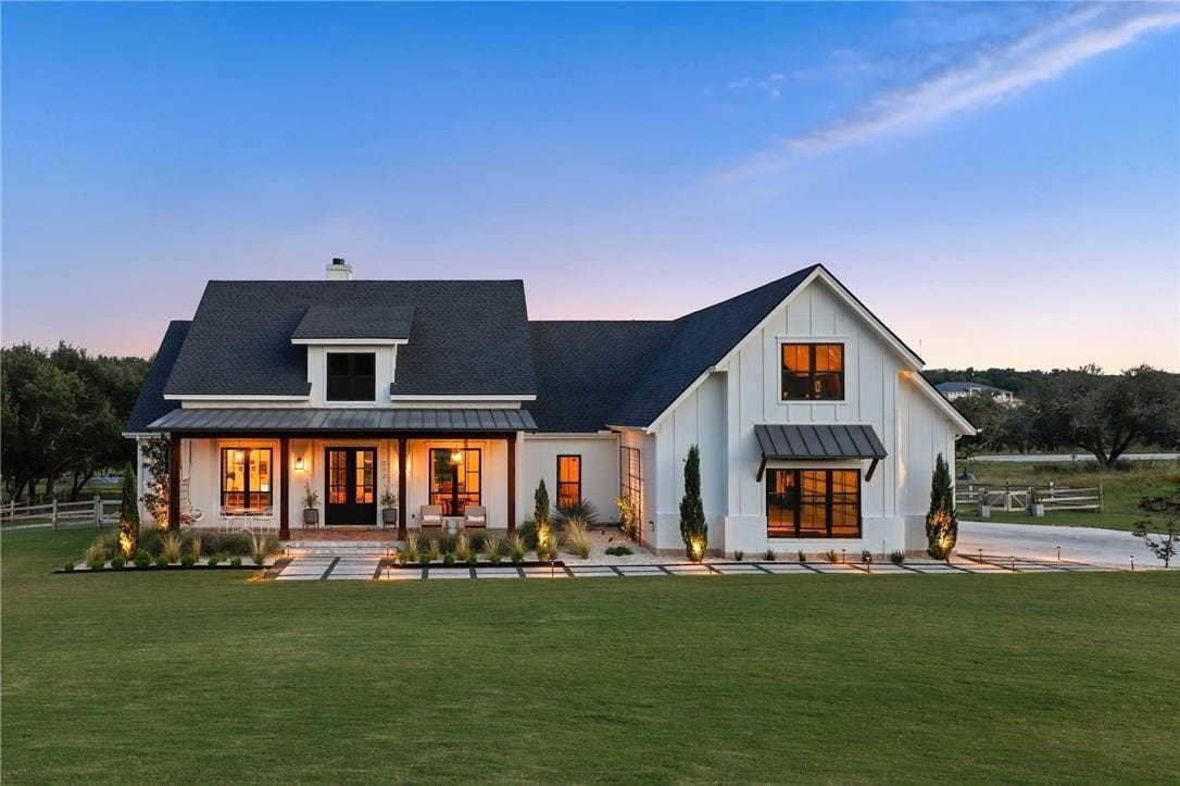 modern farmhouse with a front porch and white painted clapboard in the country